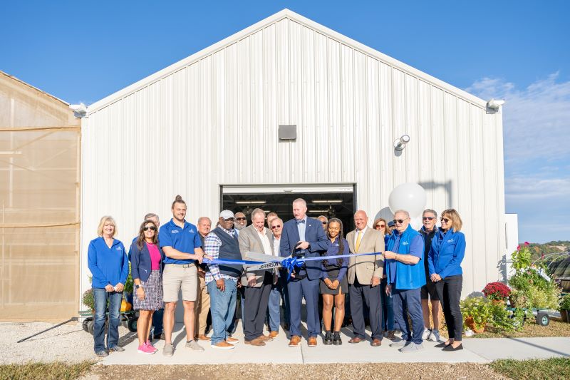 Joined by local community and state officials and supporters, Lincoln University President Dr. John B. Moseley cuts the ribbon for the University’s farm facilities expansion.