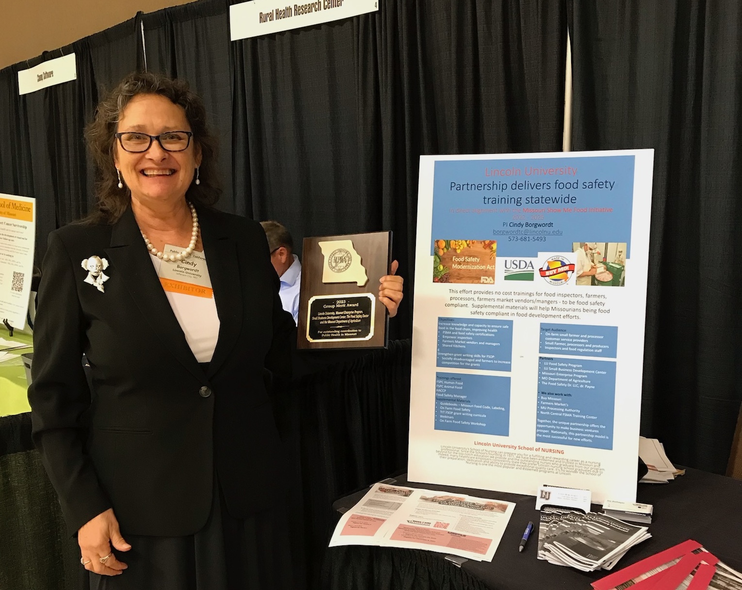 Cindy Borgwordt, food safety specialist at Lincoln University's Cooperative Research, proudly accepts the Merit Award from the Missouri Public Health Association on behalf of the dedicated Food Safety Partnership team. Their efforts in food safety education and outreach are making a significant impact on the health and well-being of Missourians.