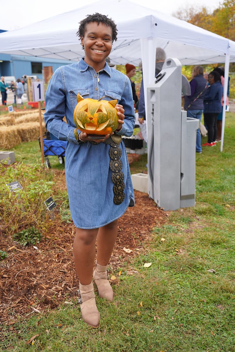 Lincoln student poses with her carved pumpkin