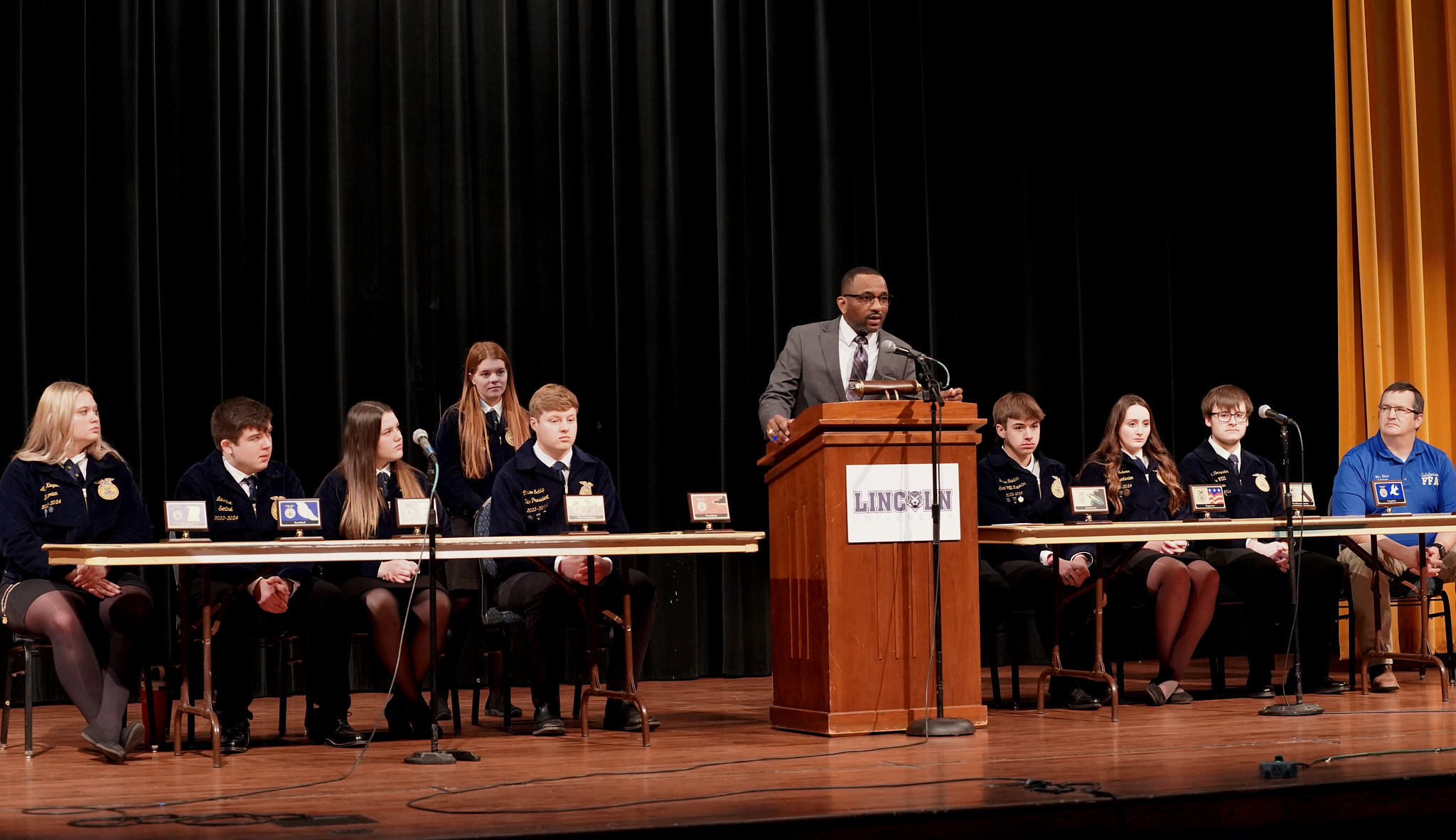 Dr. Douglas Lavergne addresses new FFA members, emphasizing the significance of maintaining a positive attitude.