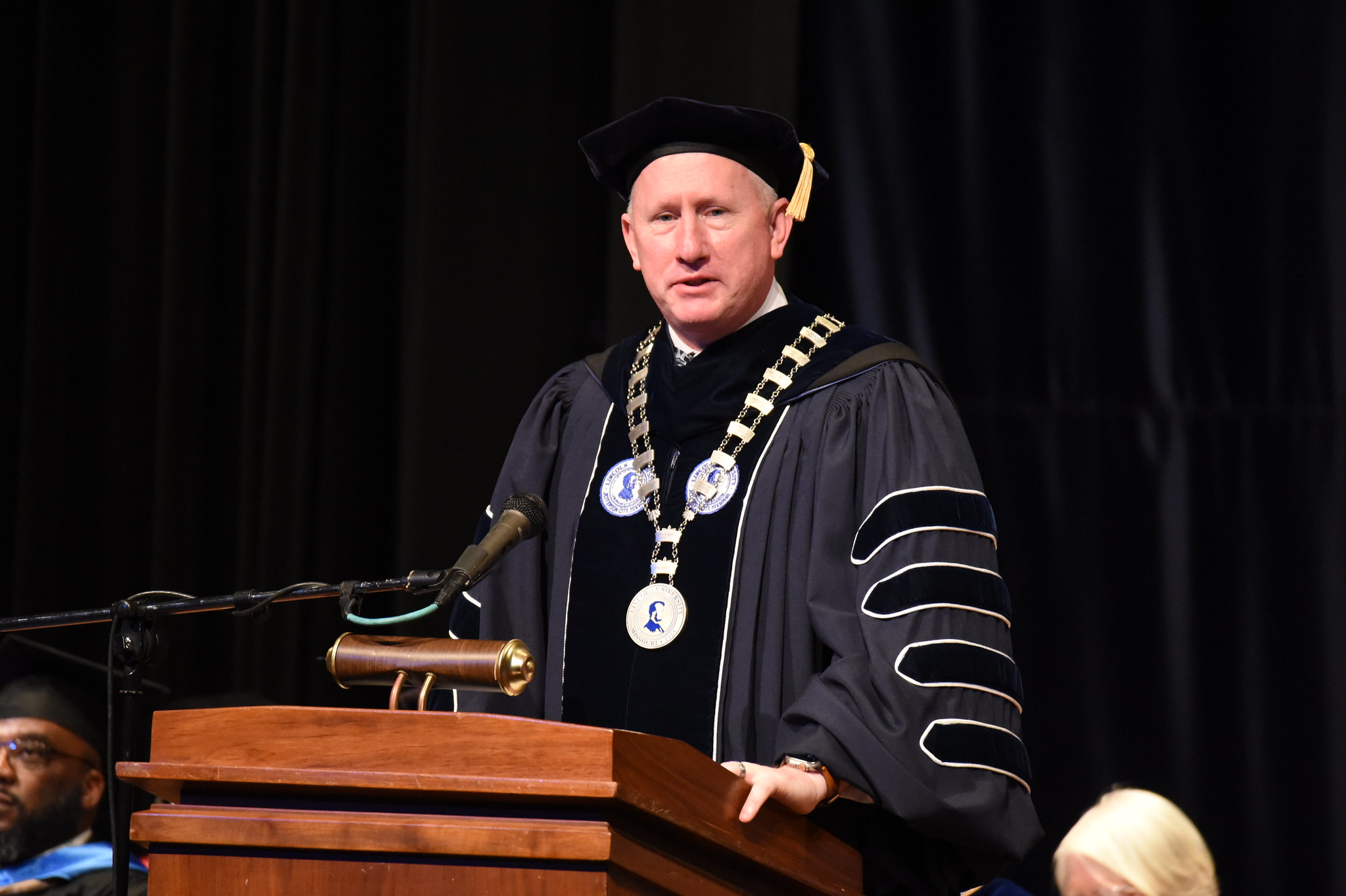 Lincoln University President Dr. John B. Moseley stands behind a podium while giving an address at the 2025 Honors Convocation. 