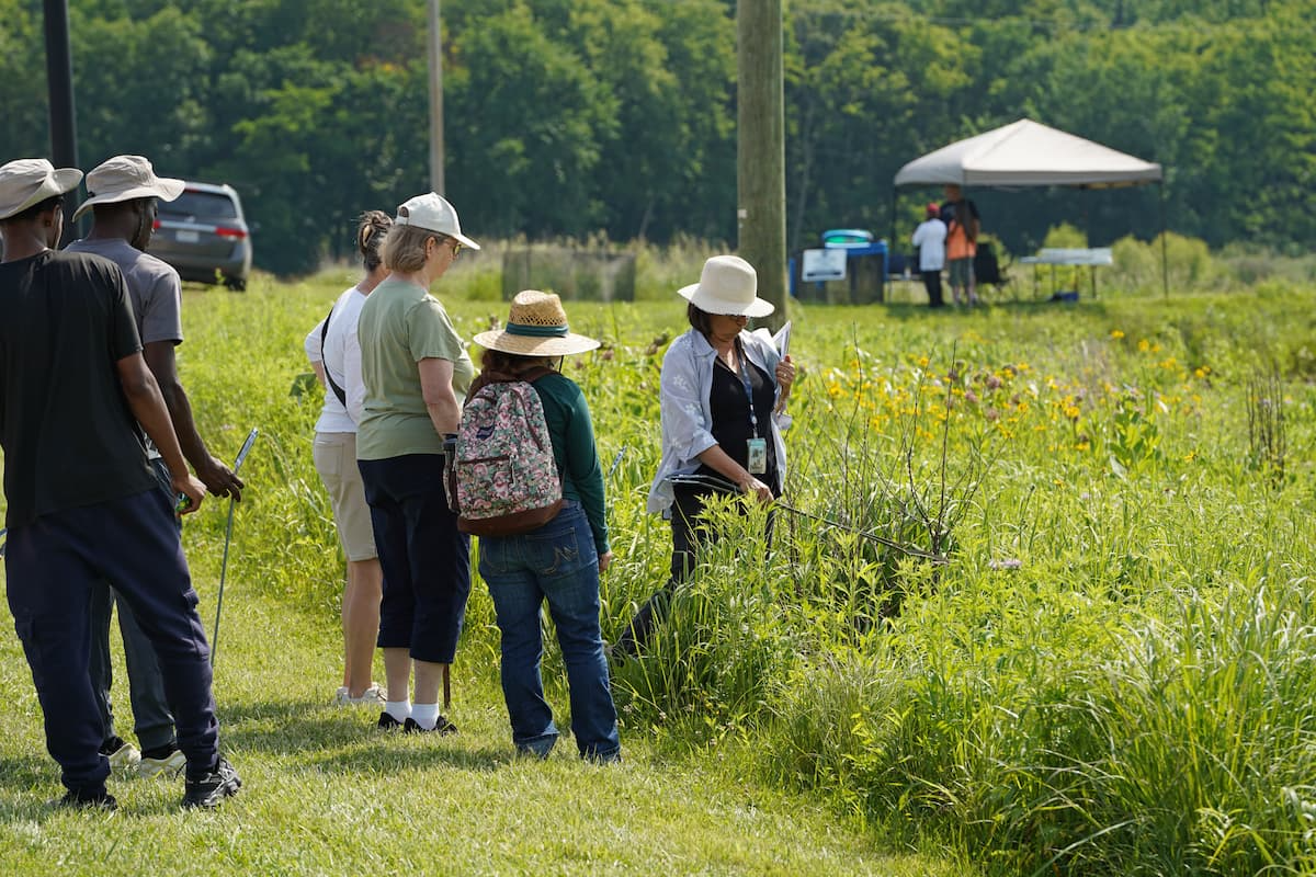 Attendees take a guided tour around the native plant prairie preservation site at Carver Farm, a demonstration area that showcases the many benefits of native plants. 
