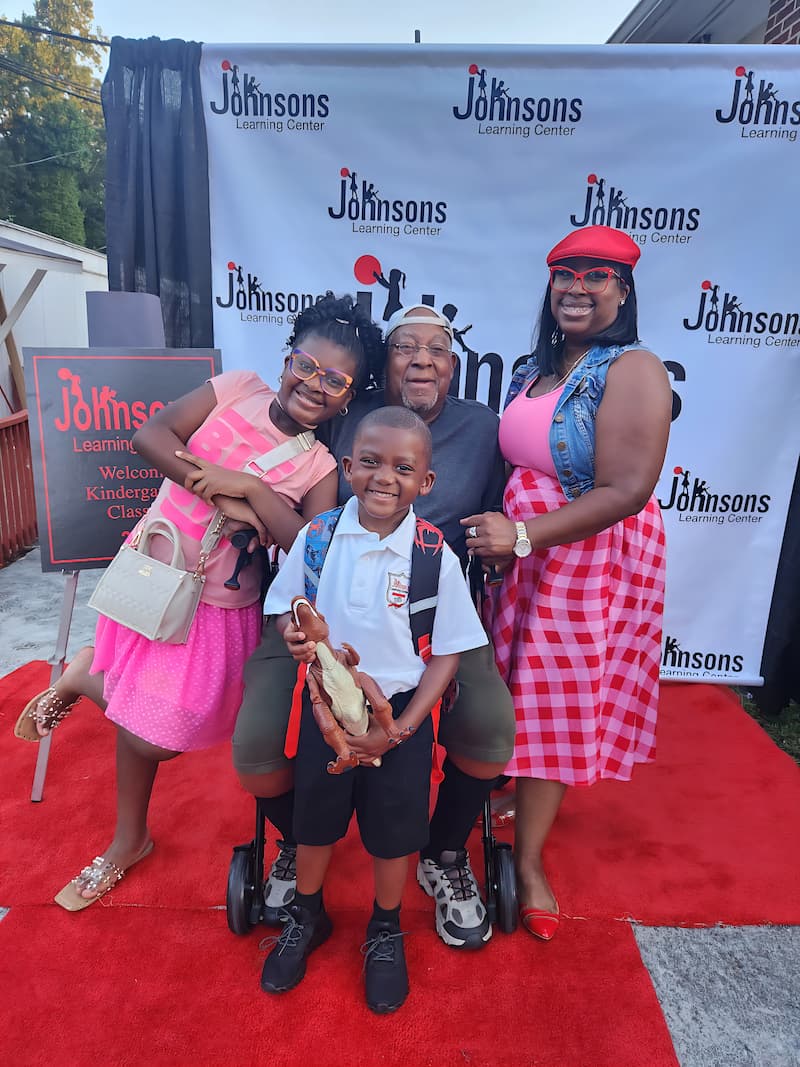 Robert Sams Jr. with his daughters and grandson.
