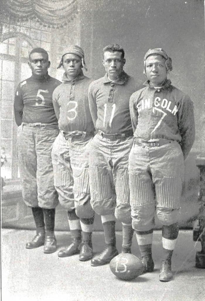 Black and white image of four Lincoln University football players in 1913 standing in a row.