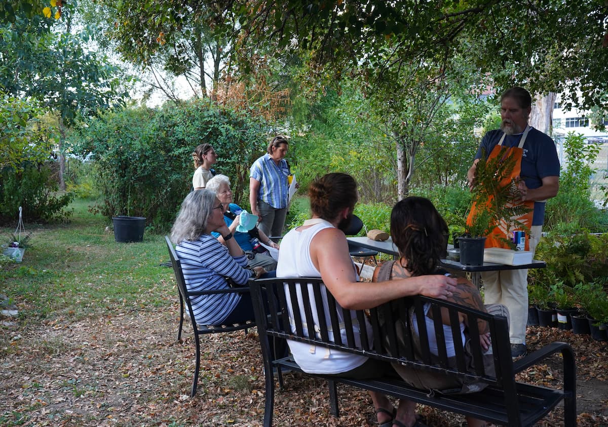 Botanist Justin Thomas of the Institute of Botanical Training talks with visitors about native ferns during the Ferntastic Fair.