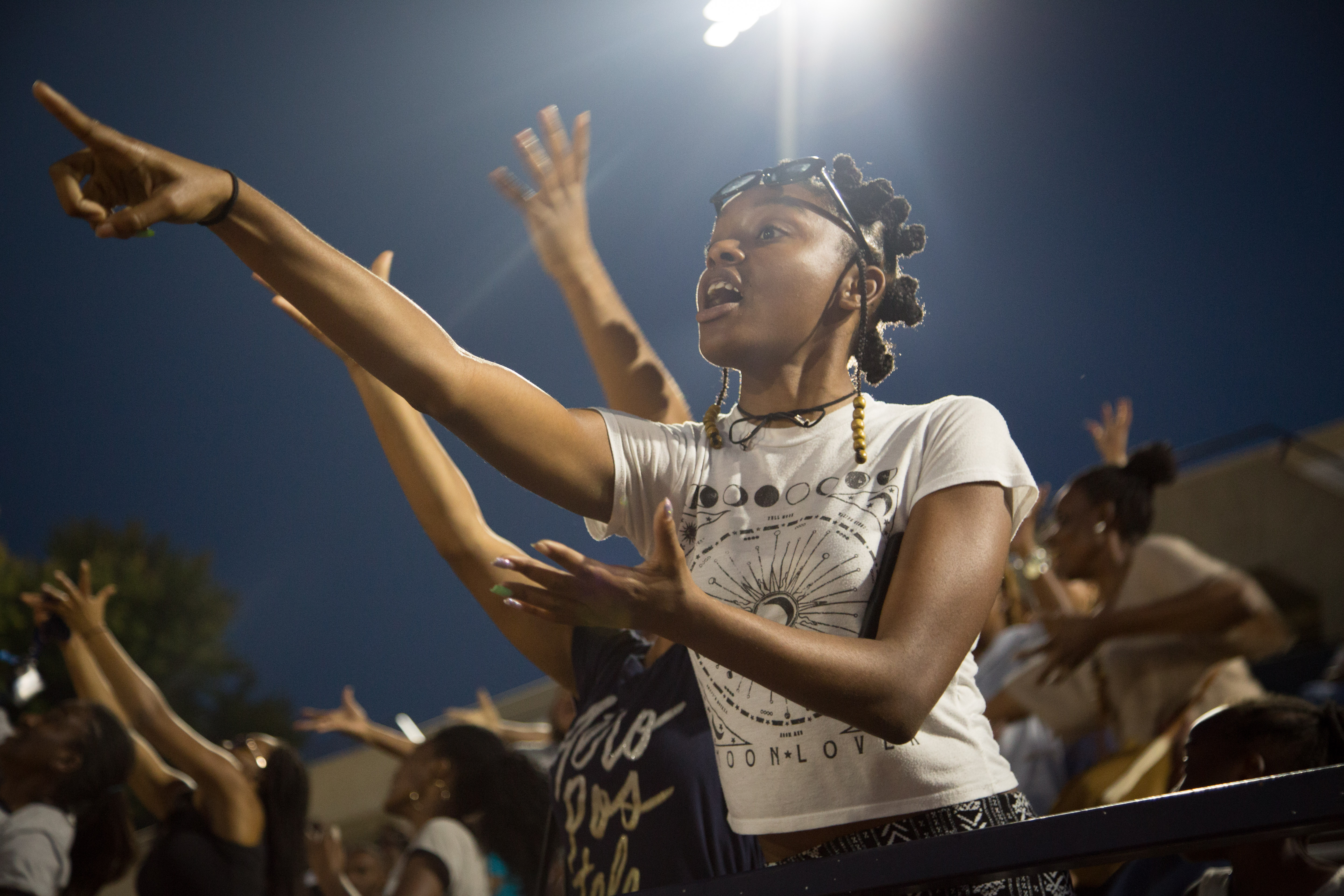 student in crowd pointing