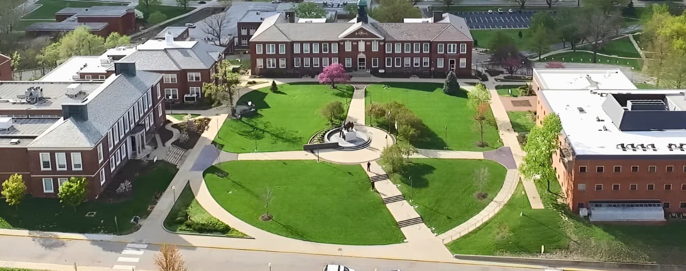 Aerial view of Lincoln University campus featuring historic red brick buildings, green lawn, and central Soldiers Memorial Plaza.