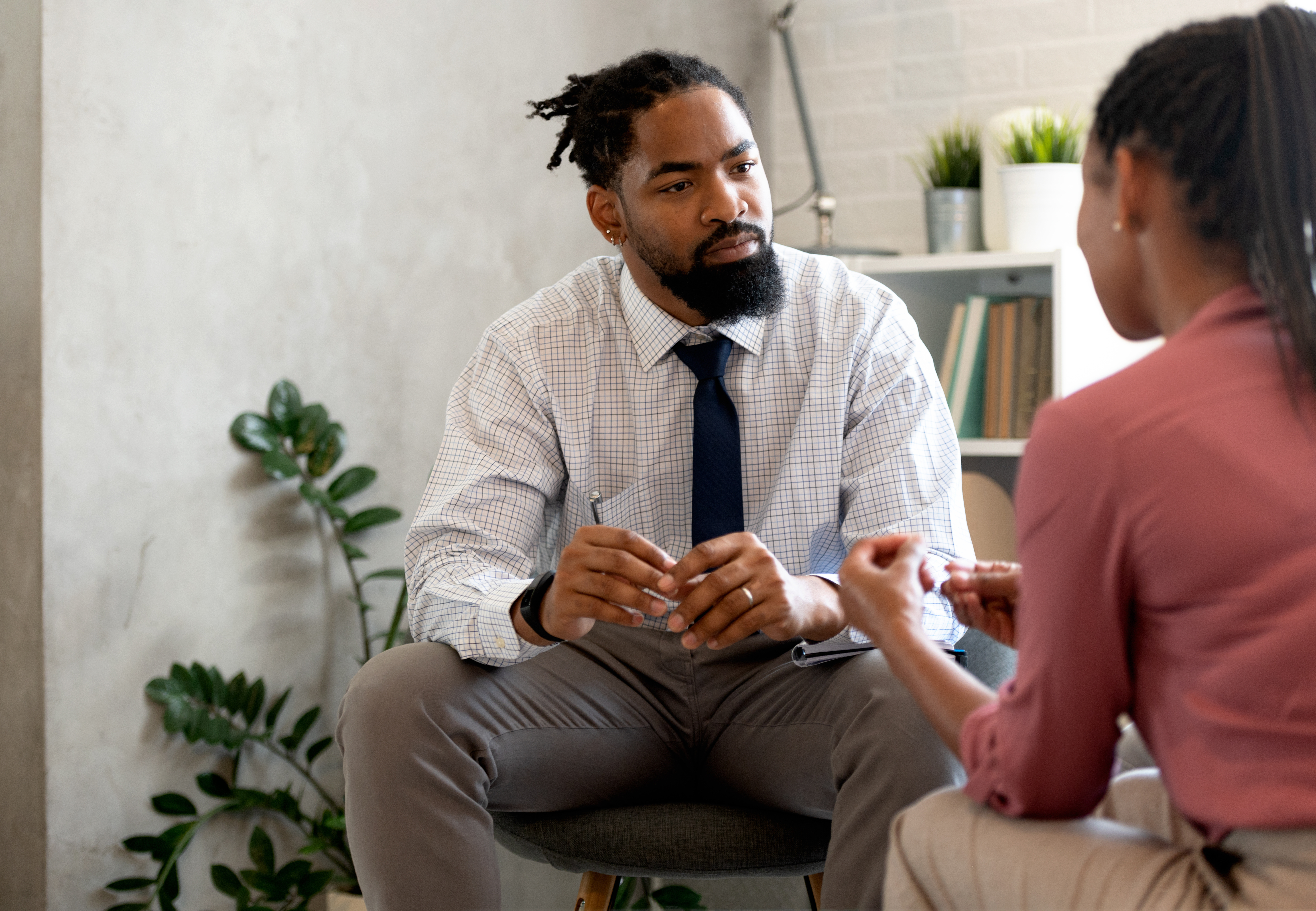 Image of a mental health professional speaking to a first responder about her experiences on the job.