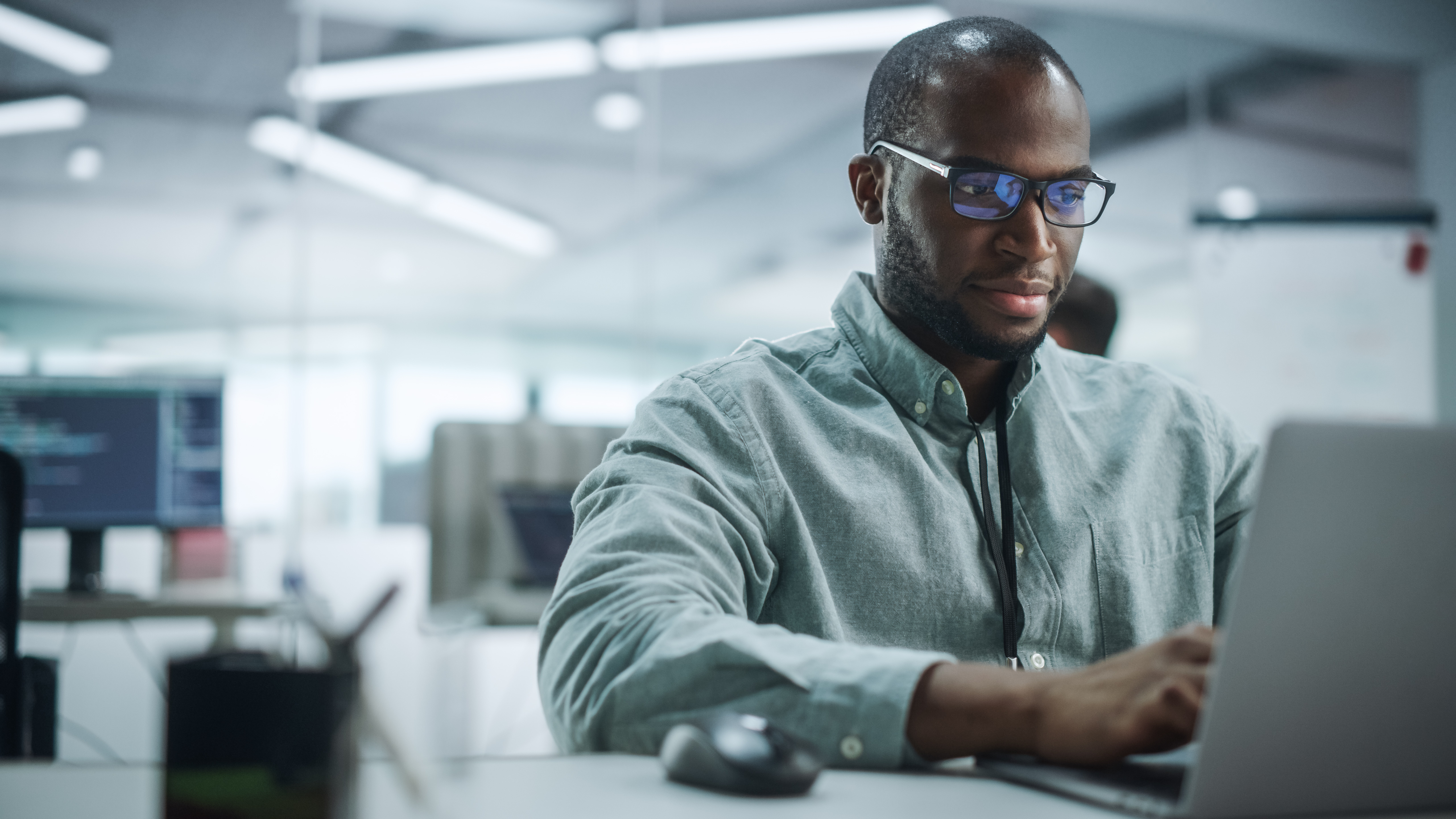 Image of a cybersecurity professional working on a laptop computer.