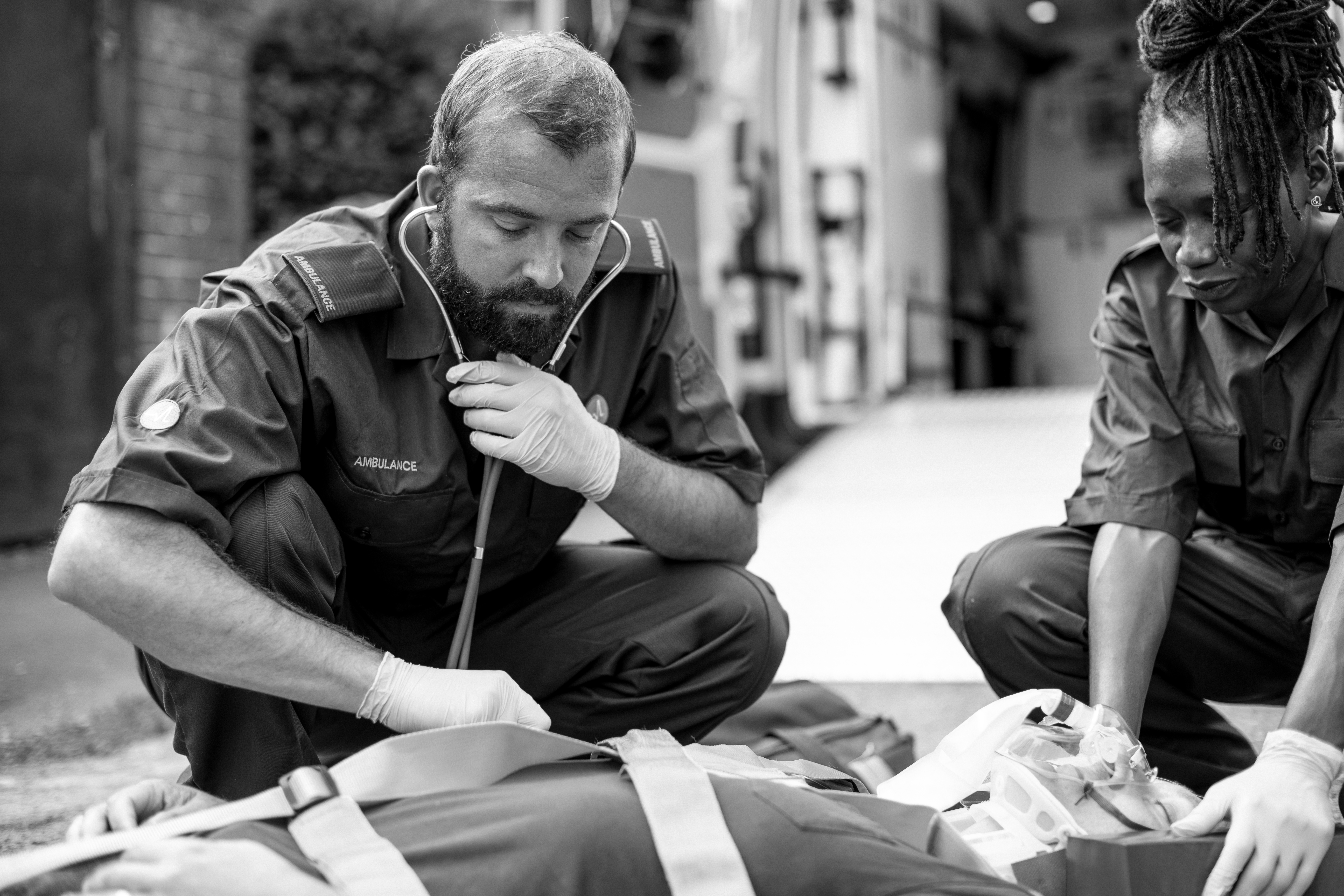 Image of two first responders performing first aid on an injured person.