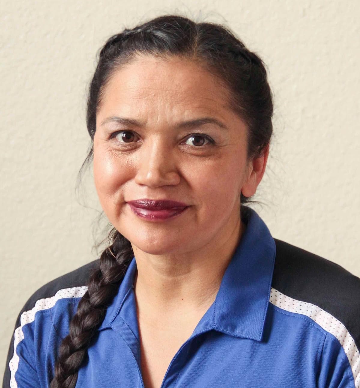 Jovita Desha, a woman with dark hair in a braid, wearing a blue Lincoln University Agriculture polo shirt
