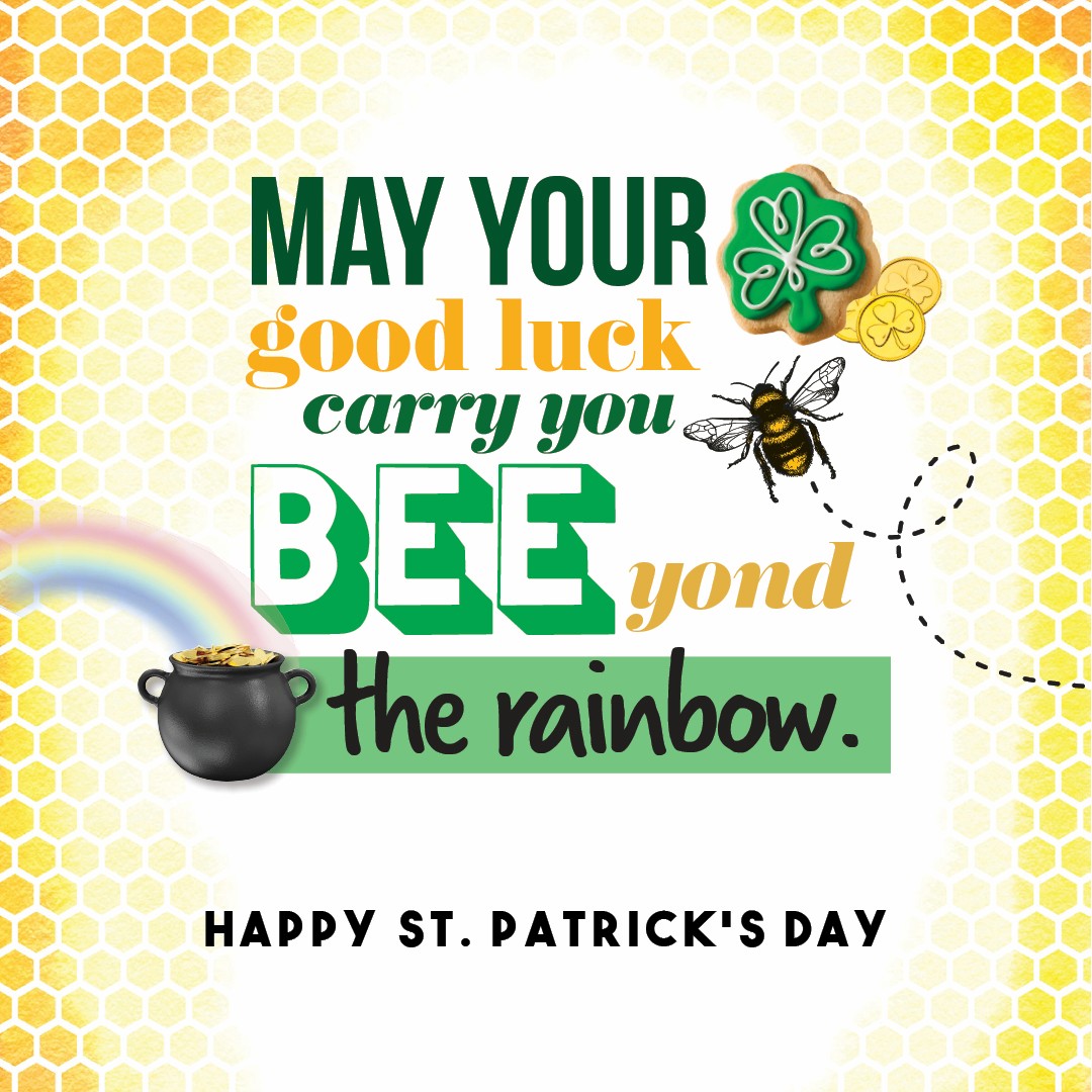 Green and gold St. Patrick’s Day graphic with honeycomb background, shamrock cookie, bee, rainbow, and pot of gold. "May your good luck carry you BEE-yond the rainbow. Happy St. Patrick's Day."