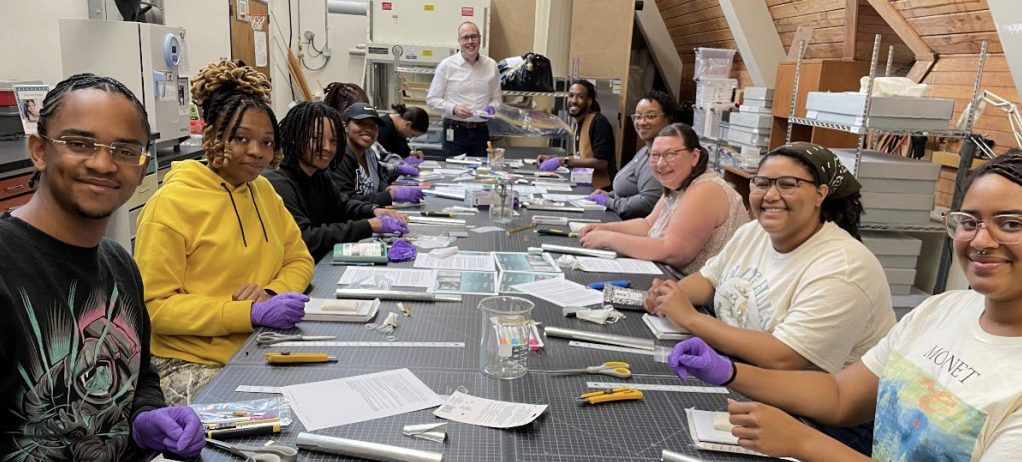 Photo of art conservation interns working at a table.