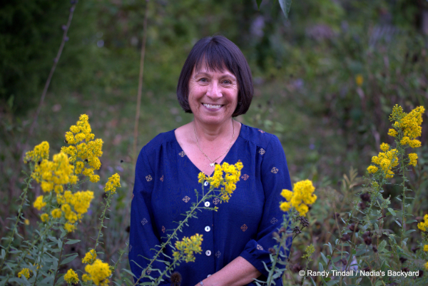 Photo of Dr. Nadia Navarrete-Tindall standing in field of goldenrod blooms