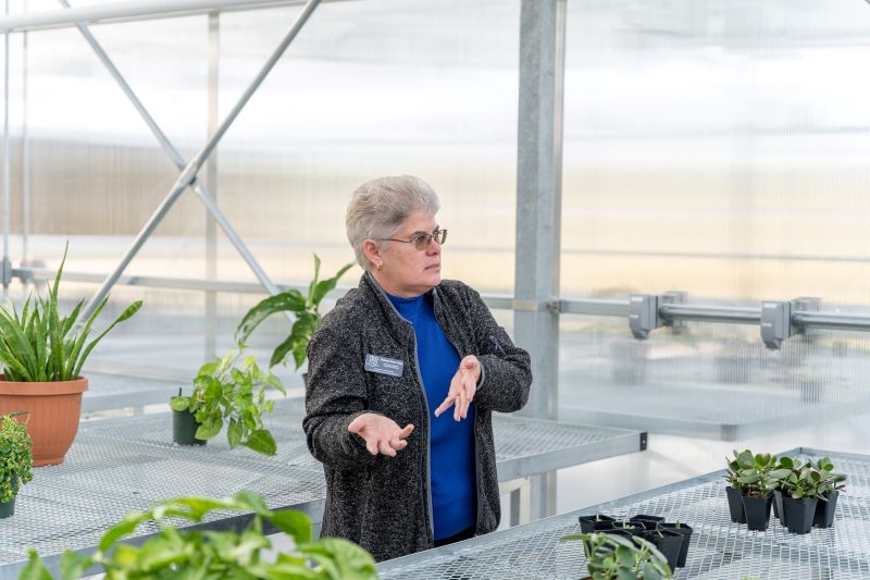 Giving a tour of Lincoln University's new Carver Farm greenhouse complex to guests on Oct. 5, Marianne Dolan Trippe, greenhouse manager, explains how the greenhouses will be used for research related to the production of industrial hemp.