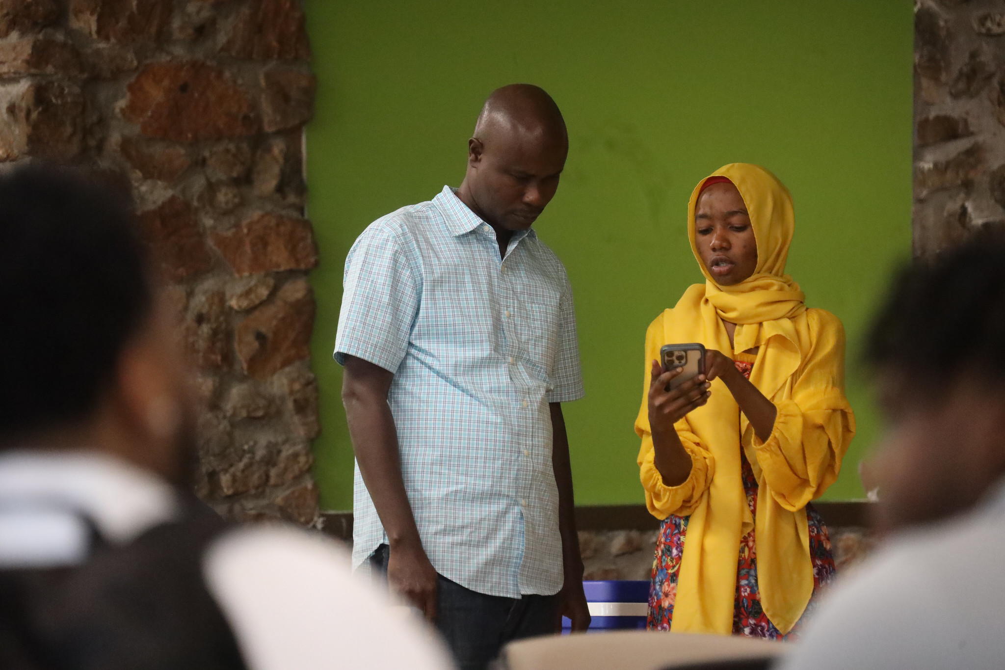 people in class showing information on phone