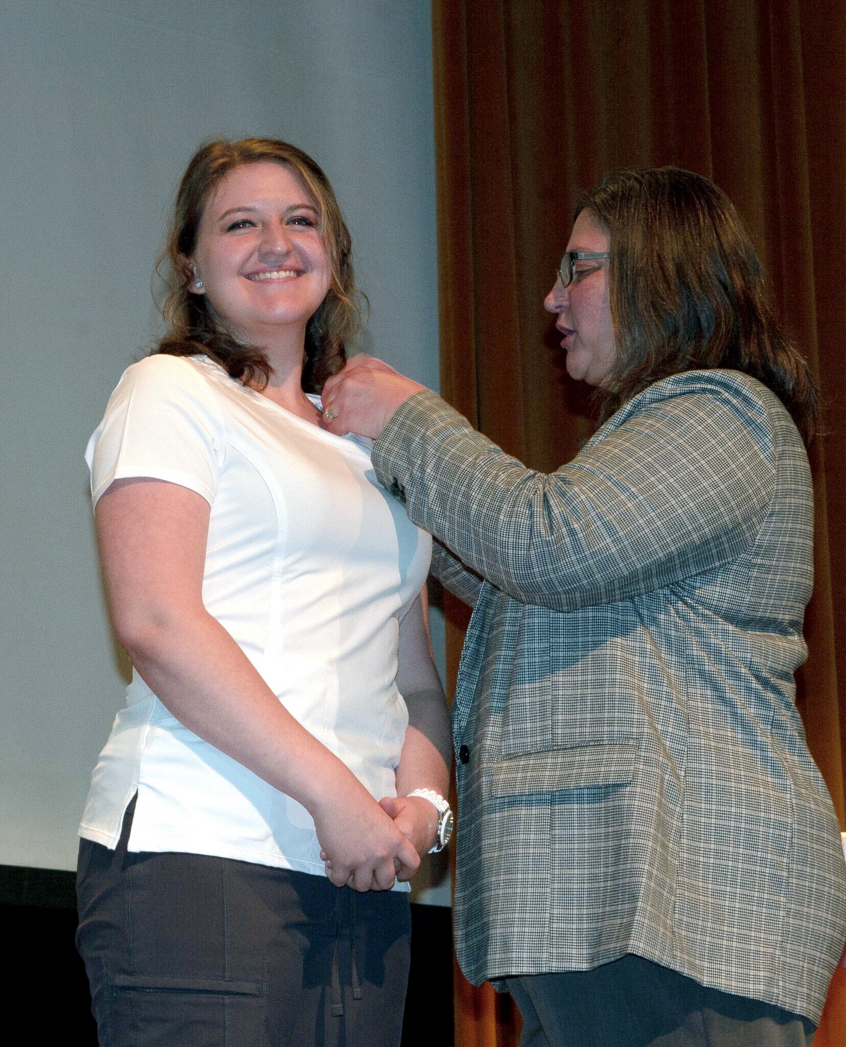 Dr. Jennifer McCord, Lincoln University School of Nursing department head, pins graduate Kaitlyn Schaben during the Dec. 16 ceremony.