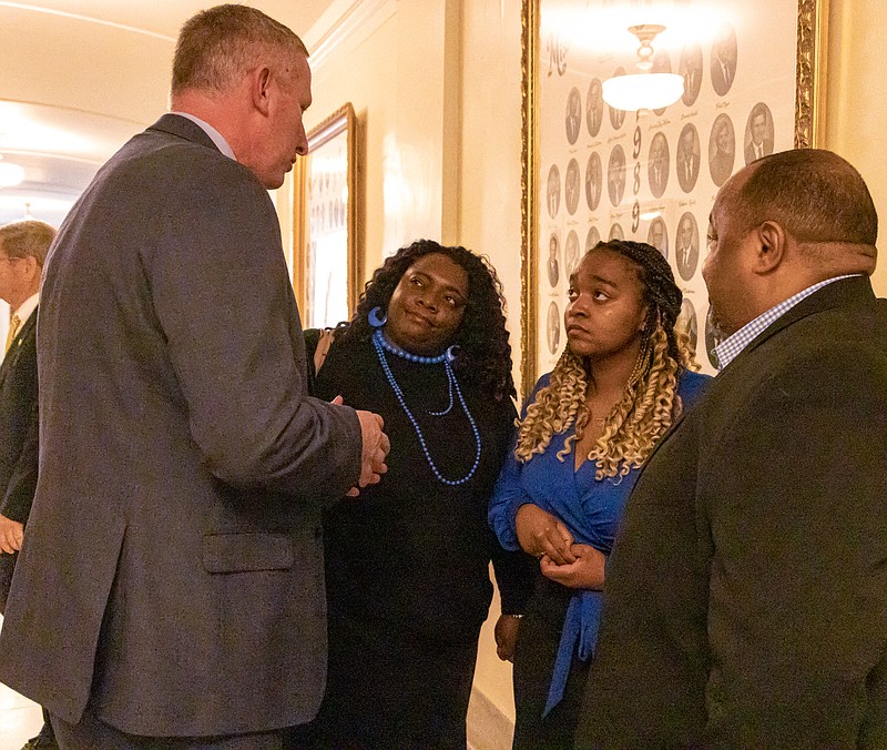Lincoln University Student Nia Walker was introduced to the Senate Gubernatorial Committee and sworn in as a member of the Lincoln University Board of Curators on April 25, 2023. Walker (second from the right) and her parents speak with Lincoln University President John Moseley (left) after her swearing in. (Photo credit: Josh Cobb/News Tribune)