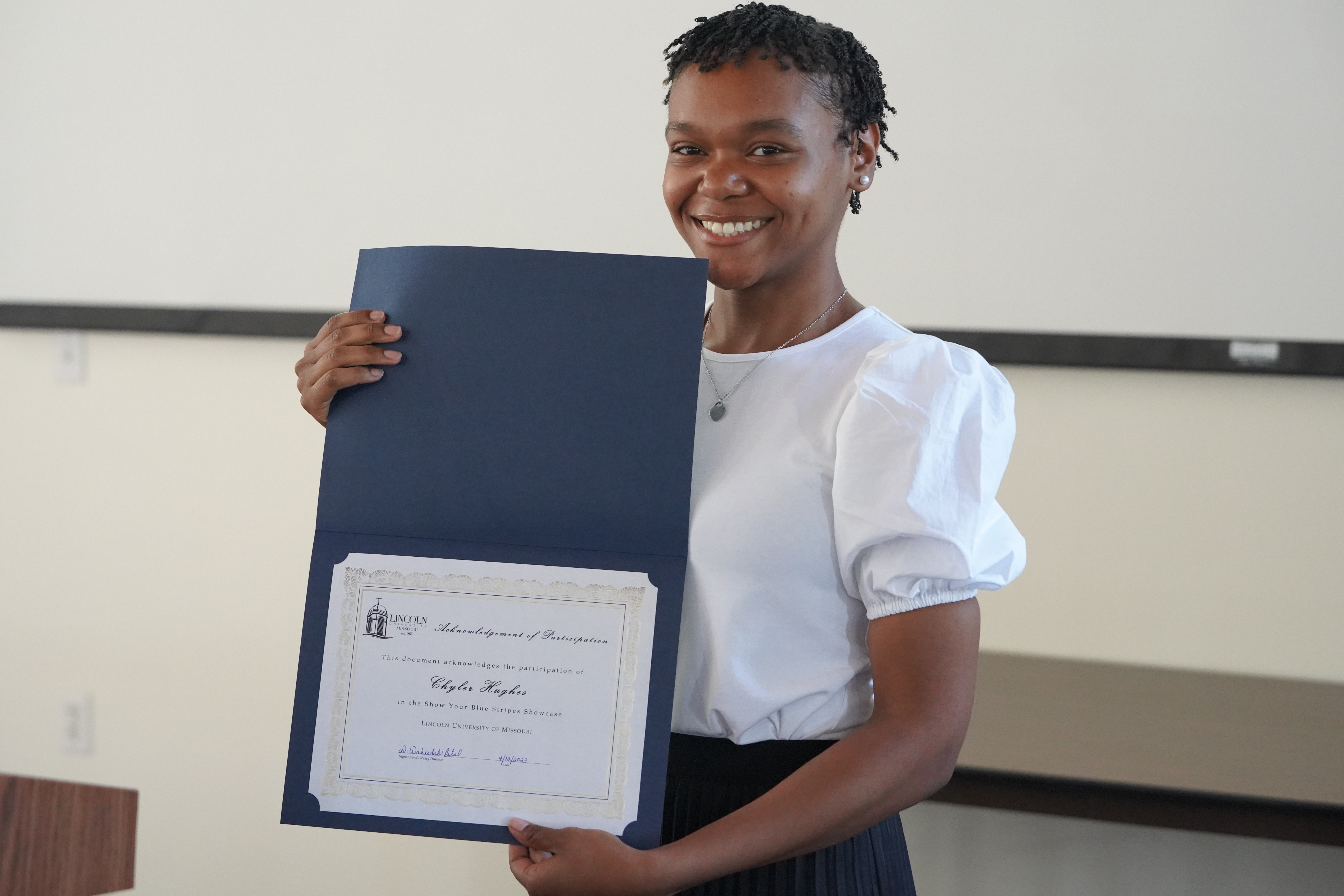 student holding a reward