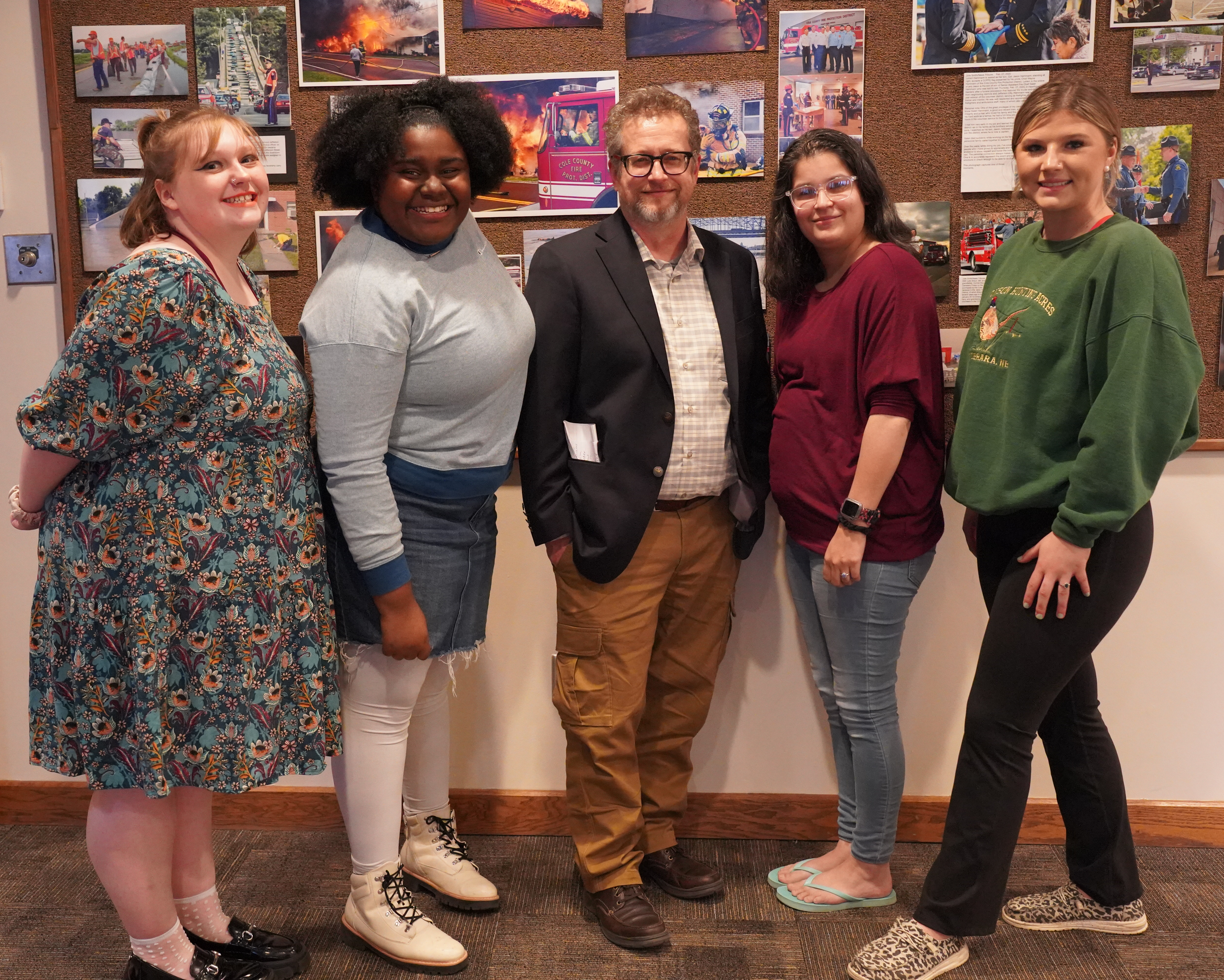 Readers Emily Botts, Chenia Walker, Izabella Ort and Jestine Lange take group photo after reading series with their professor, Daren Dean (middle). 