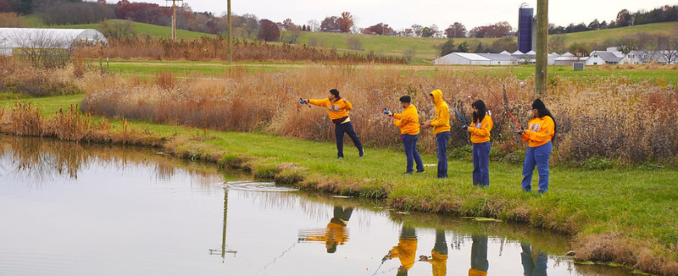  depiction of Students from Booker T. Washington engage in fishing activities at Lincoln University's Washington Carver Farm.