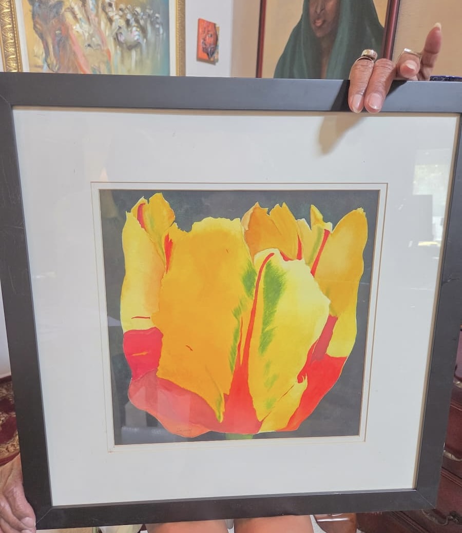Orange, yellow and red abstract painting in a black frame.