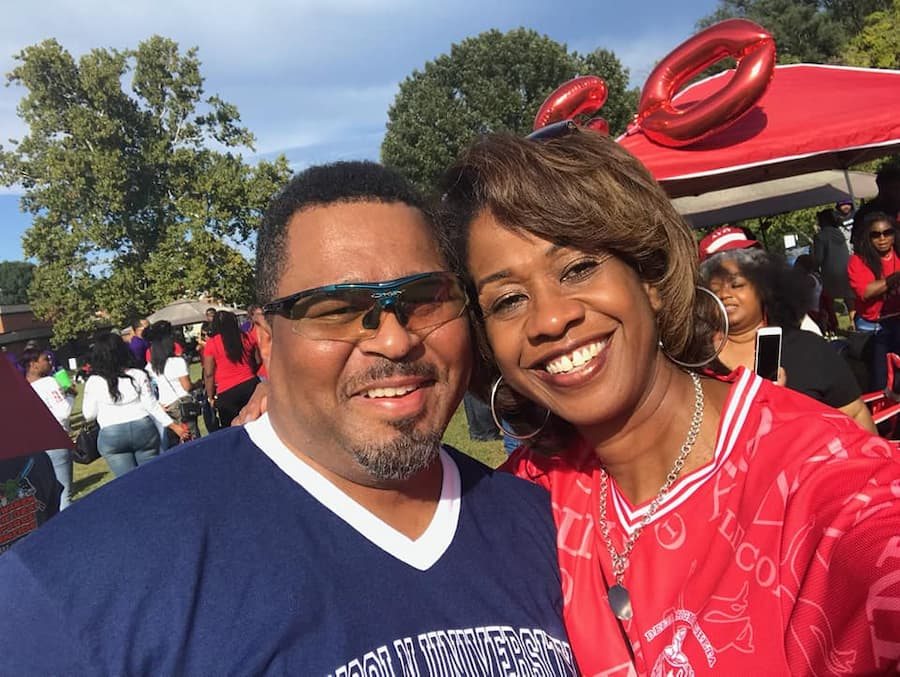 Two Lincoln University of Missouri alumni, a male and a female, smile for the camera during a Homecoming alumni event.