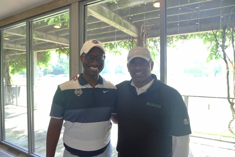 Lincoln University of Missouri golf coach Kortland Ware stand with Tony Thompson from Kwame. They are seen wearing golf polos. 