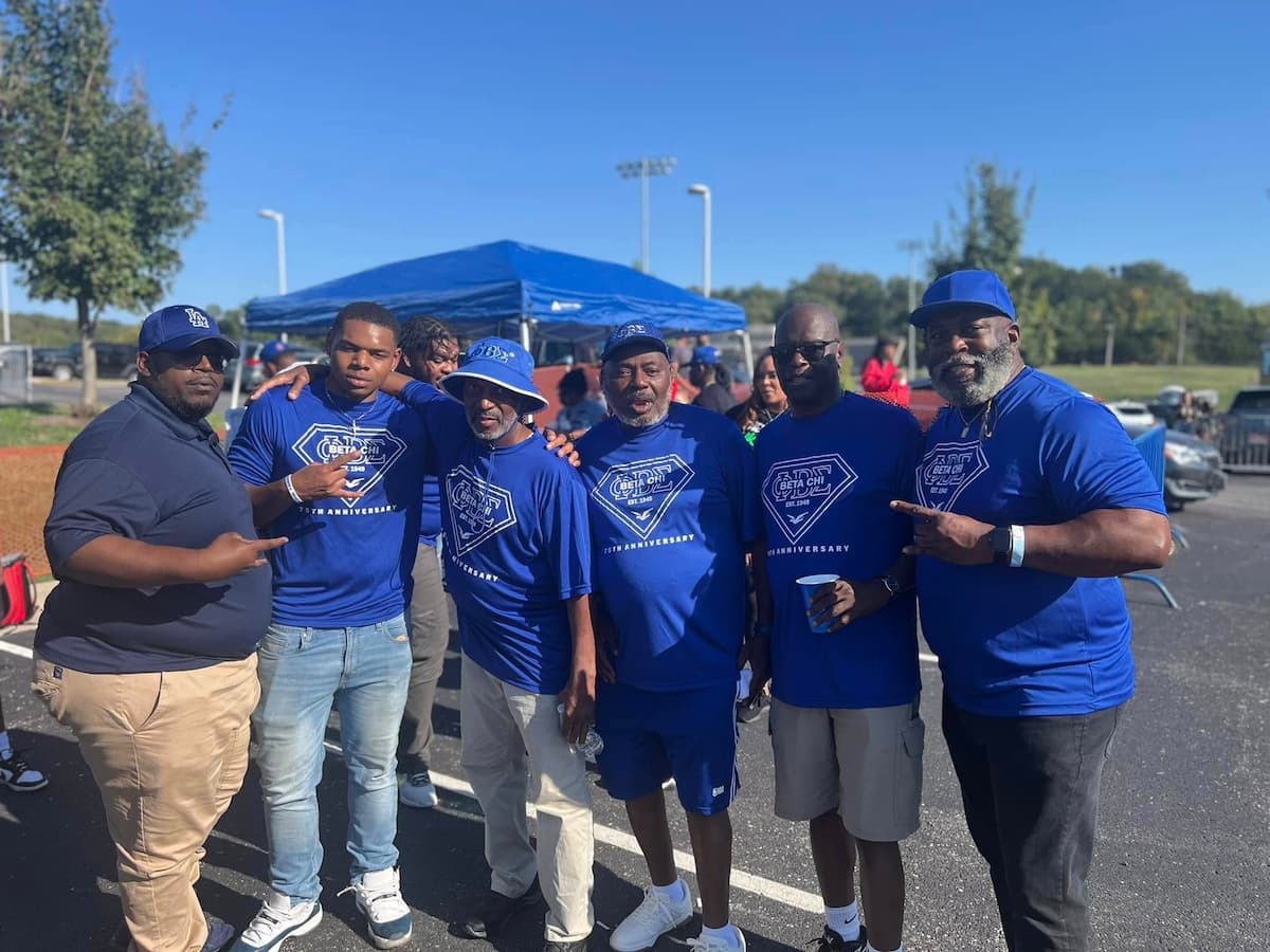 Lincoln University of Missouri alumni members pose for a group photo during a Homecoming tailgate. 