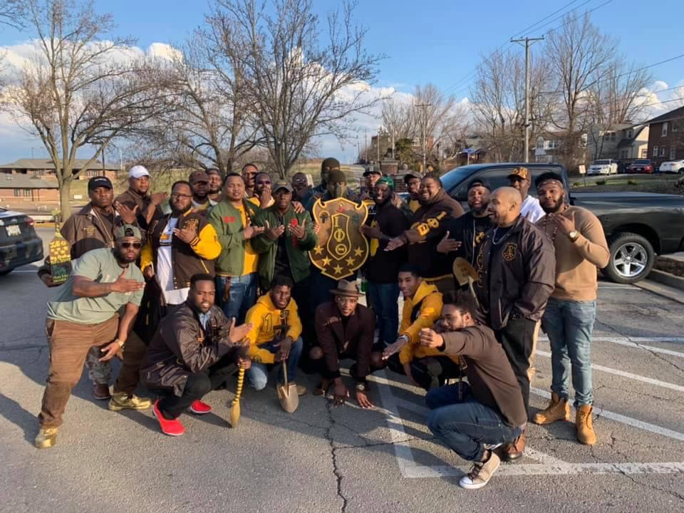 A group of Lincoln University of Missouri alumni gather for a group photo during a Homecoming tailgate.