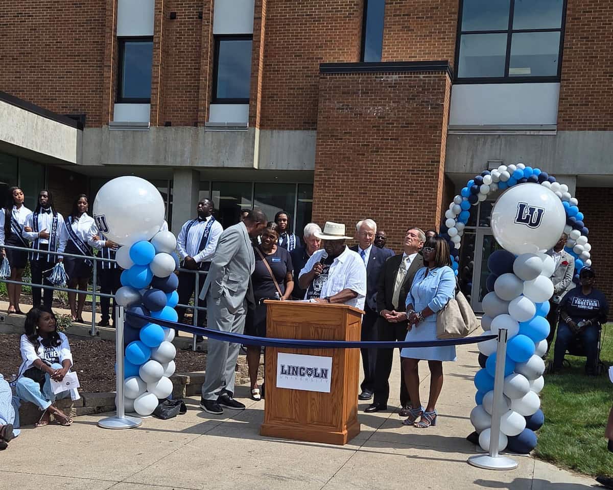 Curator Pasley at podium, Dawson Hall ribbon-cutting 2025.
