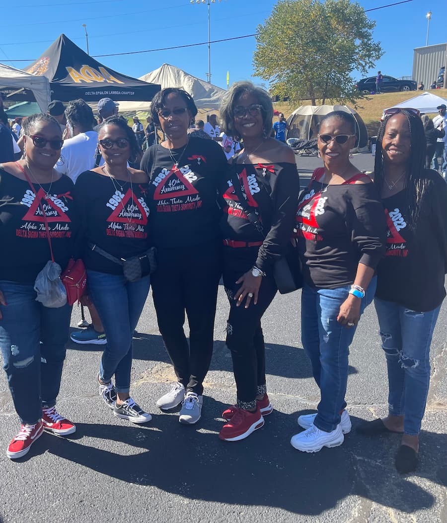 Staci Garrett Oliver and her friends stand outside in sorotity gear during Homecoming 2024.