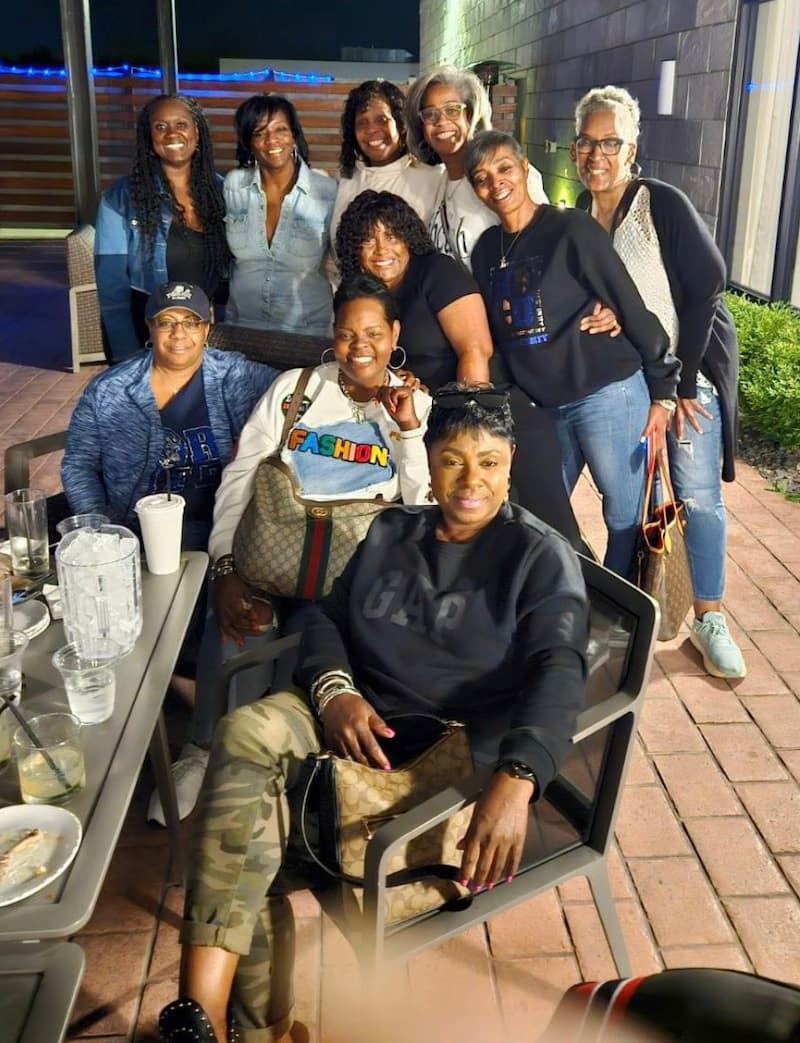 Staci Oliver and her friends sit outside at a restaurant during Homecoming 2024.