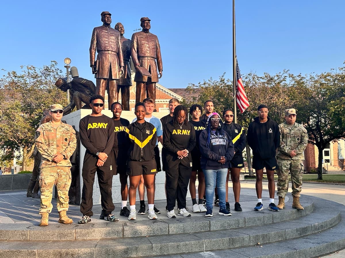 A group of Lincoln students stand in front of the Soldiers' Memorial. 