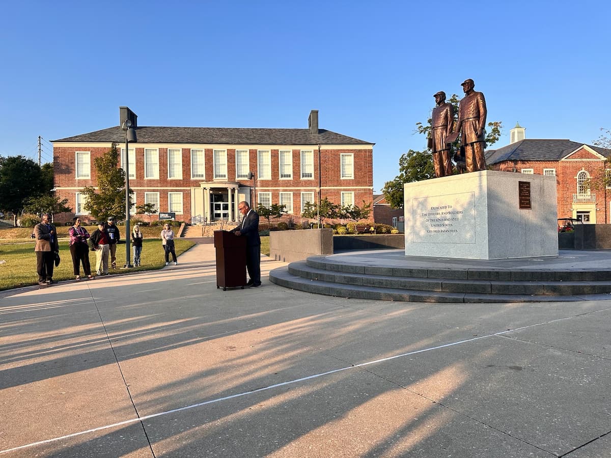 Major McQuilliams stands a podium near Soldiers' Memorial addressing community members during the Patriot Day event.