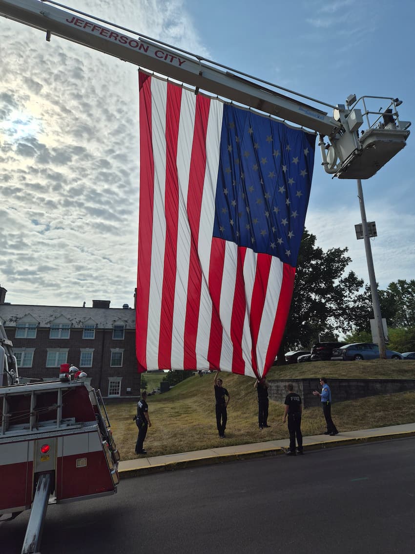 A U.S. flag is raised on the Lincoln University Quad.