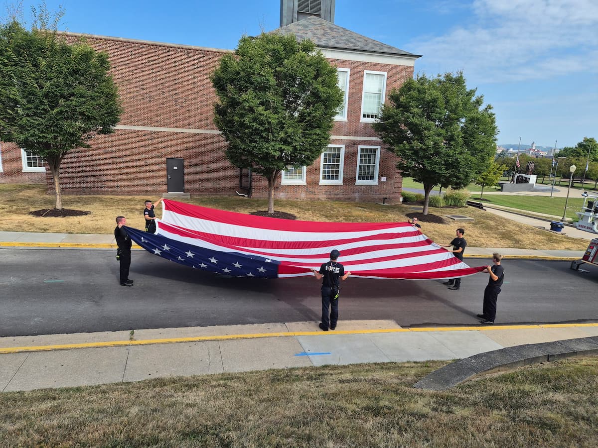 Lincoln University students carry an American flag across the Quad during the Patriot Day event.