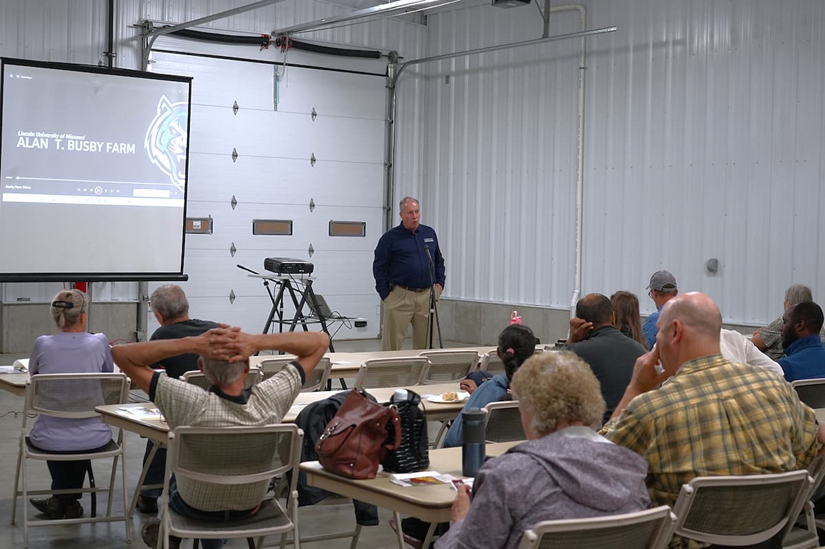 Man stands in front of a group of people.