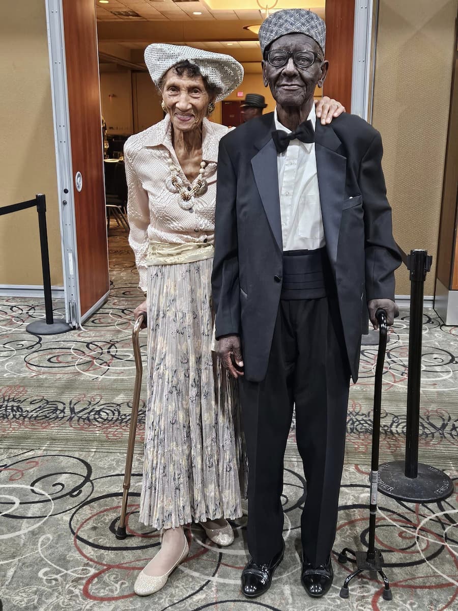 Frances and Edward Harrison smile for a photo while dressed up for an event.