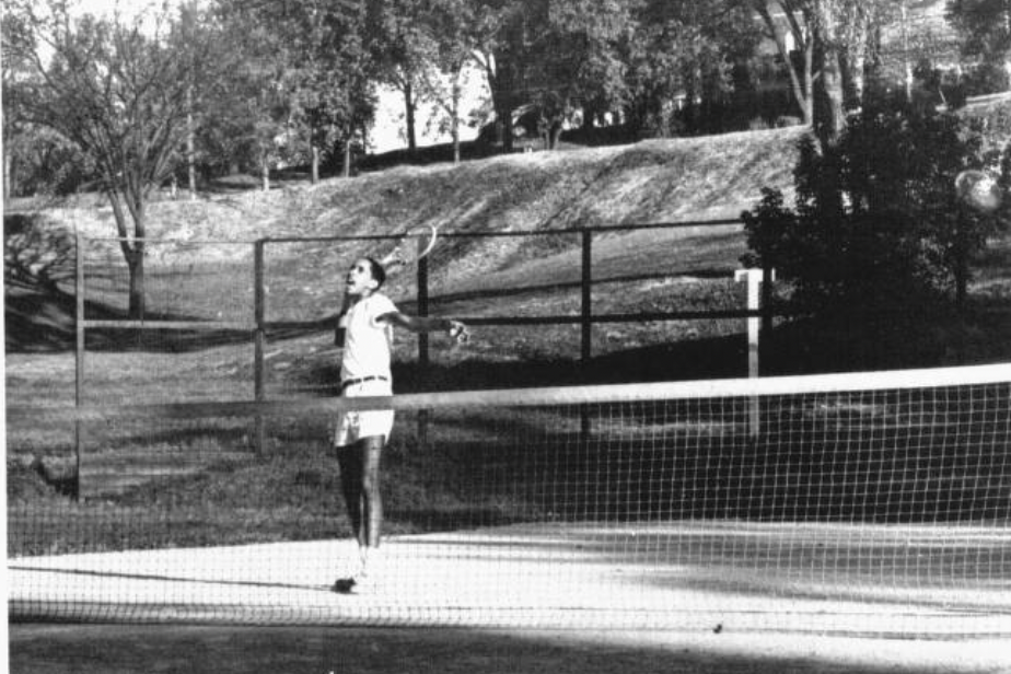Black and white image of Kelley Wilson playing tennis in 1950.