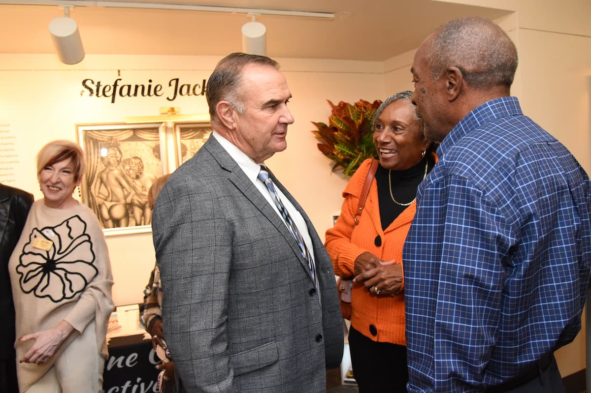 Missouri Governor Mike Kehoe speaks with community members at the Florene Dawkins exhibit. 