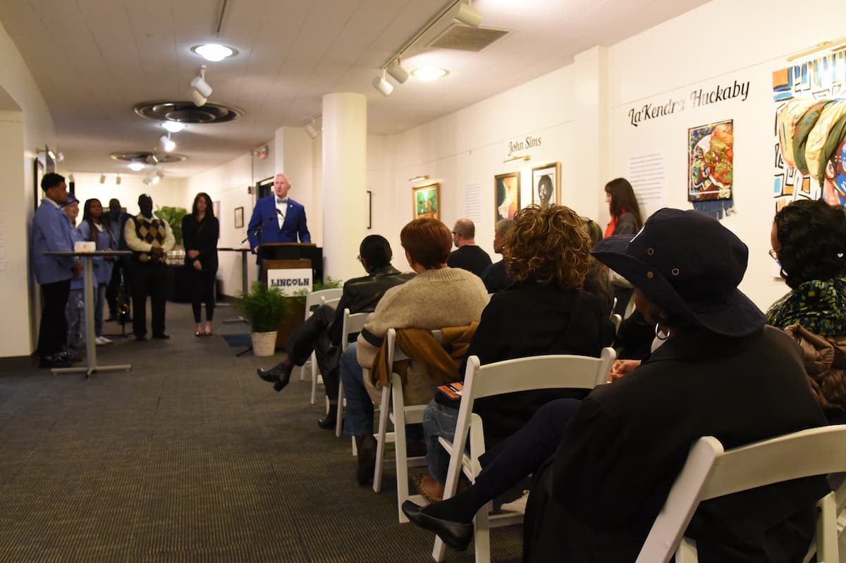 Lincoln University President Moseley stands at a podium while speaking to seated audience members.