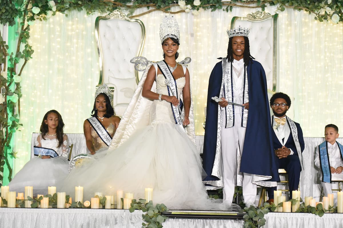 The new Miss and Mister Lincoln University stand on stage in formal attire while being crowned.