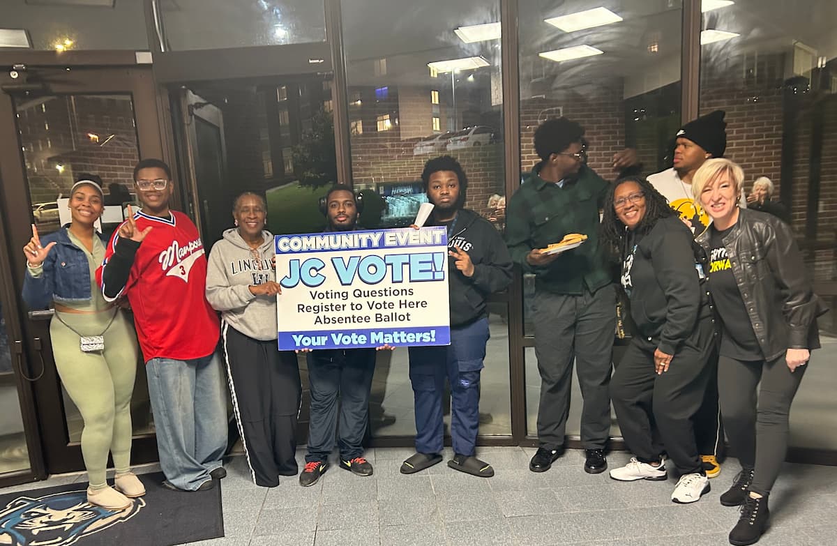 A group of Lincoln University students post with a voter registration poster while in Page Library.
