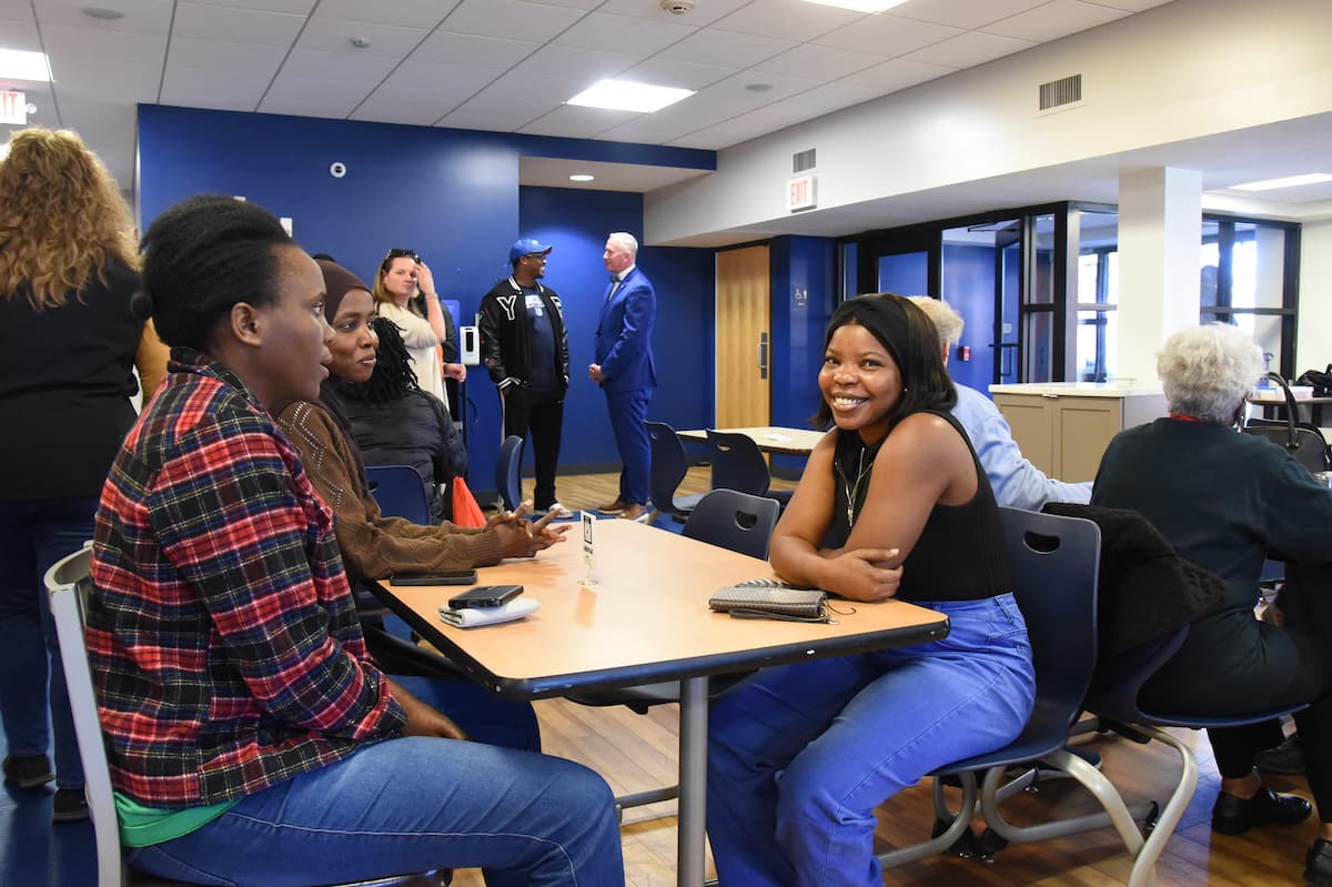 People sit at tables in the SUC cafeteria during the Slim and Husky's grand opening.