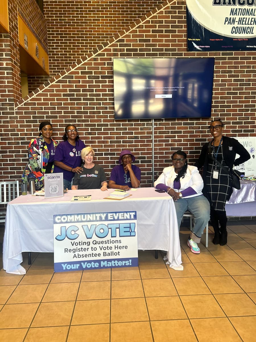 Lincoln University representatives sit at a table representing voter registration.