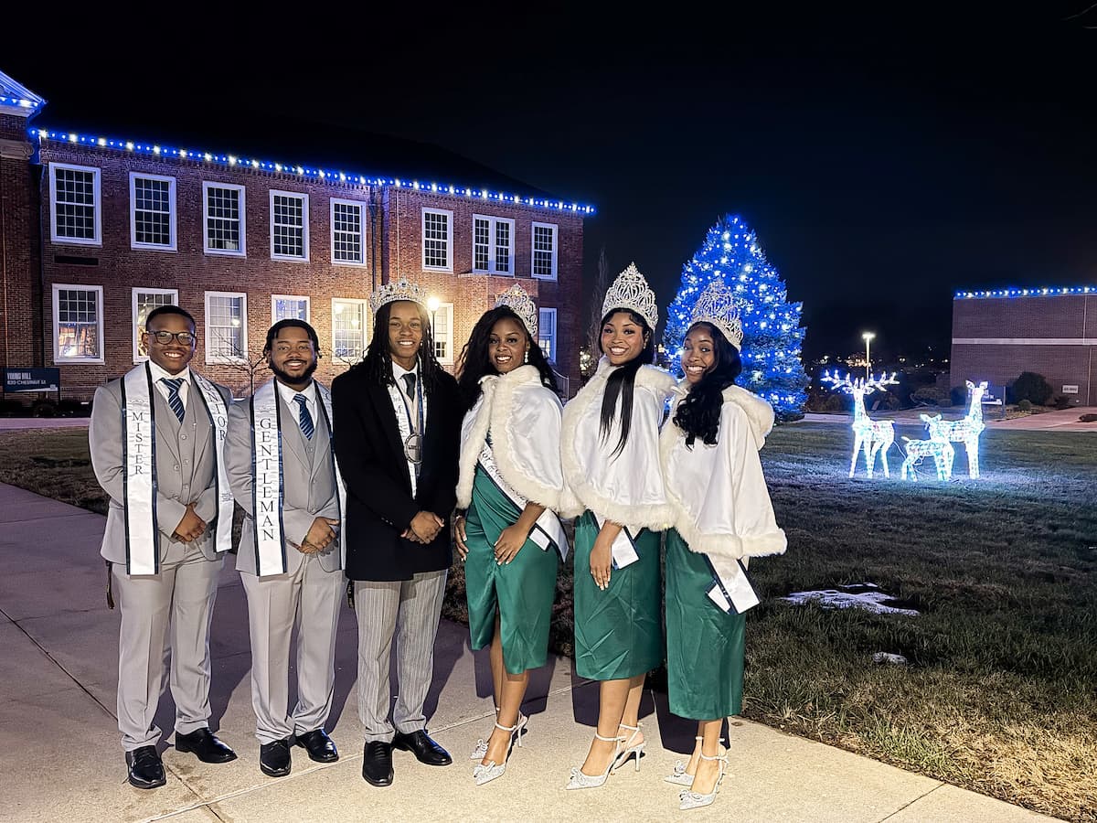 Lincoln University royalty stand in a line and pose for a photo at the Holiday Extravaganza.