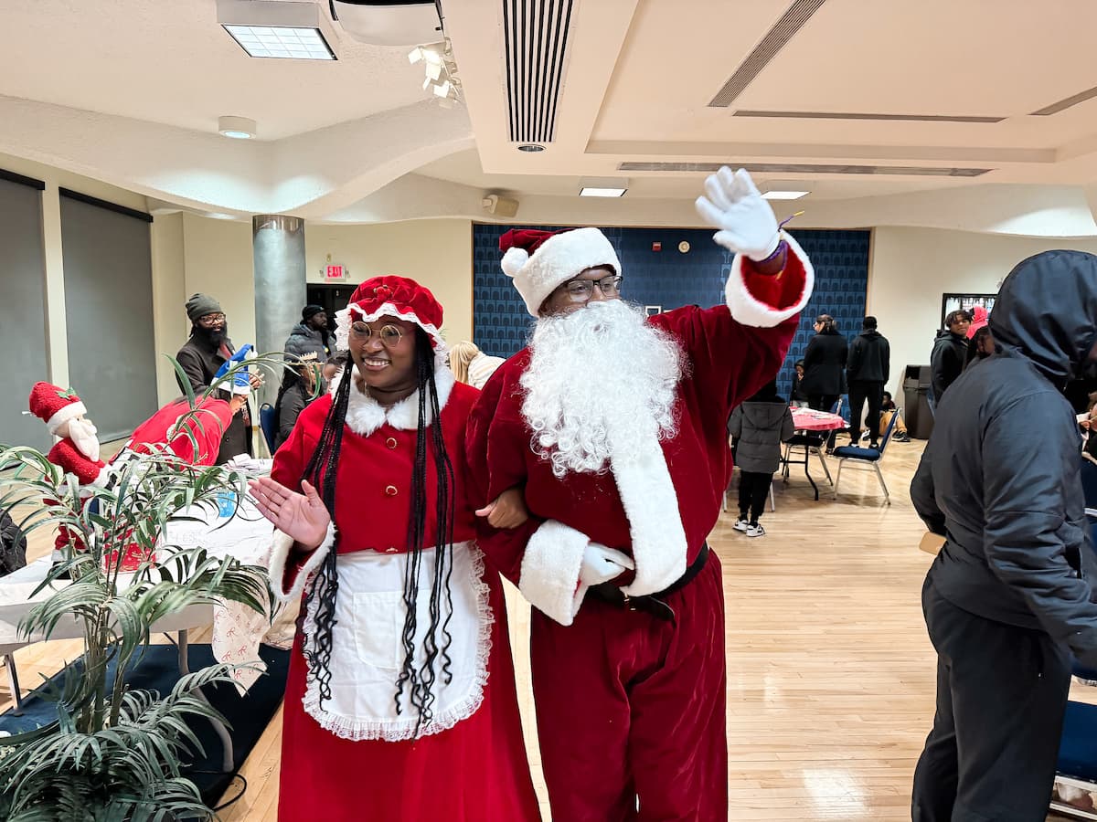 Santa and Mrs. Claus walk and wave to children at the Holiday Extravaganza.