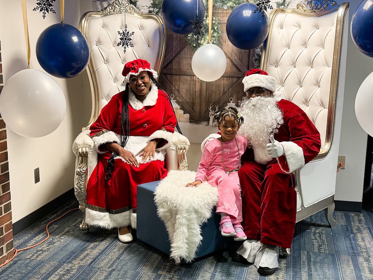 Santa and Mrs. Claus visit with a child at the Holiday Extravaganza.