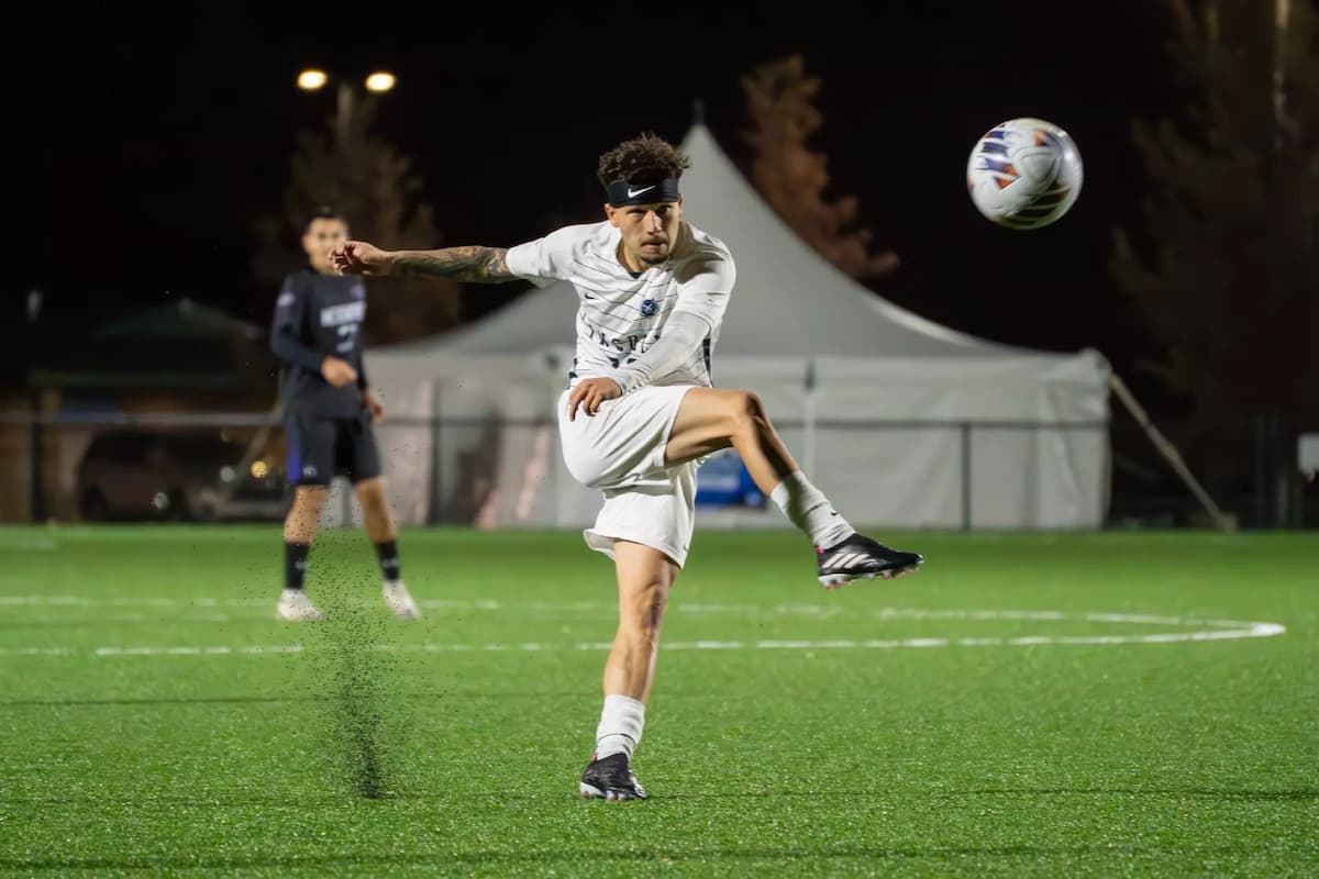 A Lincoln Univeristy soccer player kicks the soccer ball during a game.